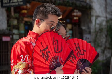 Dangkou, China - November 2019: Young Couple Dressed In Colourful Chinese Costume Posing For Pre-wedding Photos Pre-wedding Photo Shoots Are A Tradition, And Billion Dollar Industry In China Today. 