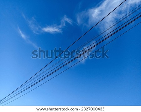 Dangling Electrical Cables with the backdrop of Beautiful Blue Sky Foto d'archivio © 