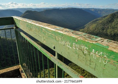 Daniel Eu Te Amo (Daniel I Love You) written on railing of Gelain Lookout Viewpoint. Beautiful landscape on background. Flores da Cunha, RS, Brazil