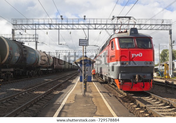 Danilov,\
Yaroslavl Region, Russia - July 25, 2017: Long-distance passenger\
train with electric locomotive CHS7-276 at the platform of the\
railway station Danilov Yaroslavl\
region