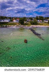 A Danish beach and a Danish boat with Danish houses. Shot with a DJI Mavic air 2S drone. 