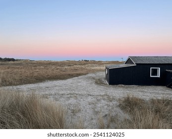 Danish Coastal Landscape at Sunset with Black Cabin - Powered by Shutterstock