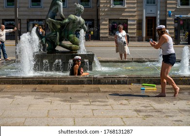 Danish High School Student With A Cell Phone Takes A Picture Of Another Girl In A Fountain Celebrating Graduation In Aarhus, Denmark On 25 June 2020