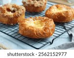 Danish pastry and apple pie pastry on a cooling rack. Perfect for recipe, article, catalogue, or any commercial purposes.