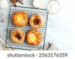 Danish pastry and apple pie pastry on a cooling rack. Perfect for recipe, article, catalogue, or any commercial purposes.