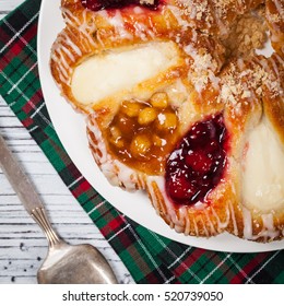 Danish Pastry Ring With Cherry, Apple Fruit And Cheese Fillings. Selective Focus.