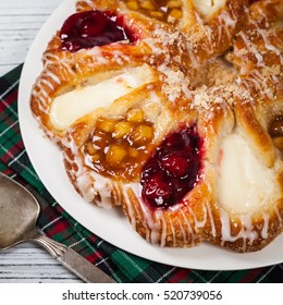 Danish Pastry Ring With Cherry, Apple Fruit And Cheese Fillings. Selective Focus.