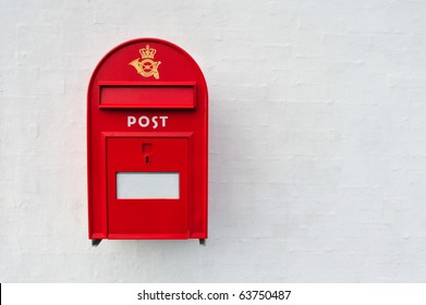 Danish Red Mailbox On White Wall Background