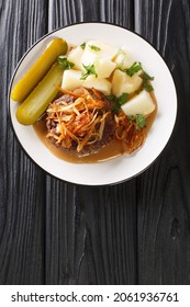 Danish Version Of Hamburgers Hakkebof With Soft Onions Served With Potatoes And Brown Gravy Close Up In The Plate On The Table. Vertical Top View From Above
