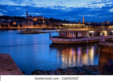 Danube River At Blue Hour Twilight In City Of Budapest, Hungary, Cruise And Dinner Boat, View From Pest To Buda Side.