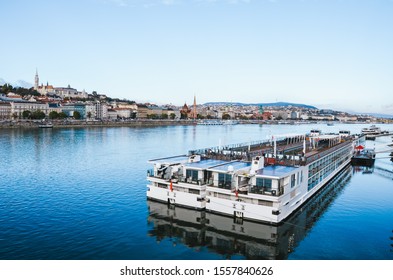 Danube River In Budapest, Hungary With Large Cruise Boats On A Cold Winter Day. Historical Center Of The Hungarian Capital In The Background. Air Pollution From Cruises Is Environmental Problem.