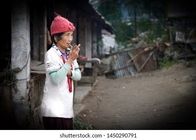 Daporijo/India-01.12.2018:The Old Woman Smoking Pipe On The Street