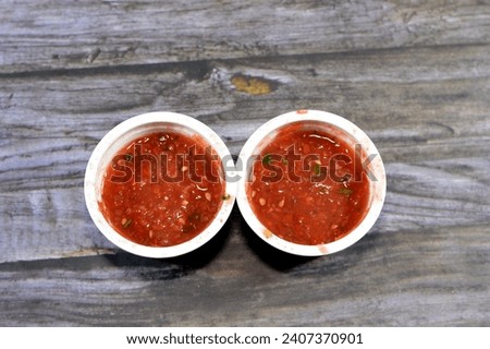 Daqoos or Daqqus, a Kuwaiti or Gulf Arabic tomato sauce that is combine with garlic and olive oil, fresh tomatoes, tomato paste, garlic, salt, sugar, water, olive oil and commonly used with Mandi