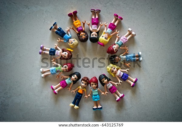 Dar es Salaam, Tanzania, 16 January 2017 - Lego\
figurines from the Friends series arranged in a circular order\
depicting a harmony, happy and playful mood of children viewed from\
the top.