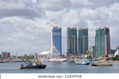 Dar Es Salaam, Tanzania, December 20th, 2017. Tall Buildings And Ferry In Dar Es Salaam Harbour