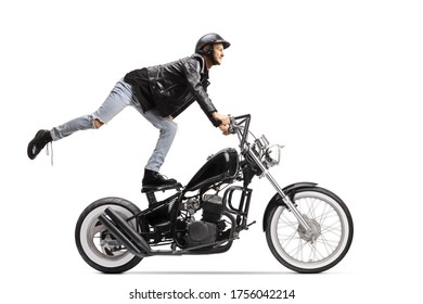 Daredevil Biker Standing On The Seat And Riding A Chopper Motorbike Isolated On White Background