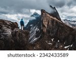 A daring climber conquering the jagged mountainous heights of the Dolomites, part of the Alps in Italy