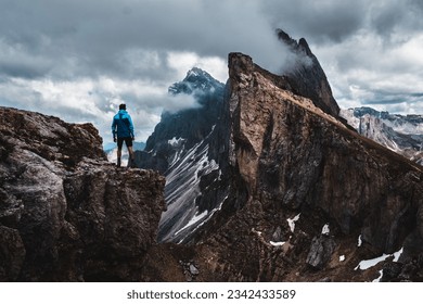 A daring climber conquering the jagged mountainous heights of the Dolomites, part of the Alps in Italy's South Tyrol region