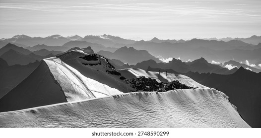 Daring climbers navigate the sharp and steep summit ridge of Piz Palu, surrounded by breathtaking alpine views and glistening snow in the Bernina Range of Switzerland during summer.