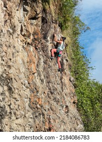 Daring Rock Climber Girl Lead Climbing Outdoors