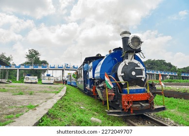 Darjeeling Himalayan Railways toy train heading to the Darjeeling from Siliguri station. The most attractive tourist ride of this region which is recognized as UNESCO world heritage site. - Shutterstock ID 2272049707