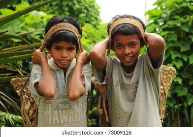 DARJEELING, INDIA - AUGUST 16: Unidentified Young Boys Work Hard As Porters Instead Going To School On August 16, 2010. Child's Work Is A Global Problem. INDIA