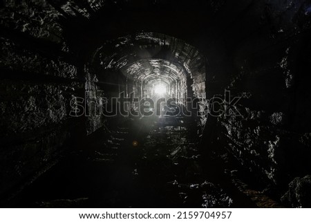Dark abandoned mine in backlight.