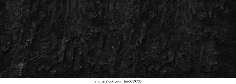 Dark aged shabby cliff face volcanic hillside. Coarse, rough gray volcanic stone or rock texture of mountains, background and copy space for text on theme geology and volcanic eruption study.