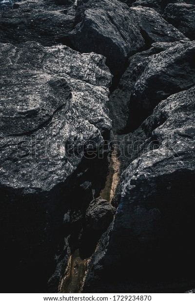 Dark Aged Shabby Cliff Face And Divided\
By Huge Cracks And Layers. Coarse, Rough Gray Stone Or Rock Texture\
Of Mountains, Background And Copy Space For Text On Theme Geology\
And Mountaineering.