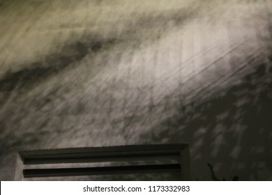 Dark air vent with dramatic shadows.