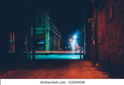 Dark alley and light trails in Hanover, Pennsylvania at night.