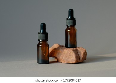 Dark amber glass dropper bottles mockup. Natural organic essential oil packaging design. 
