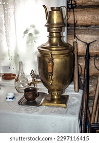 dark antique copper samovar on the table, an authentic thing