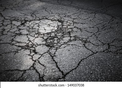 Dark Asphalt Road With Cracks. Background Texture