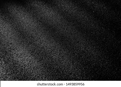 dark asphalt road with light and shadow
