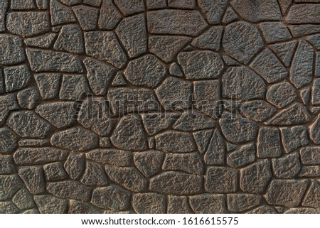 Dark assembled stone wall backdrop
Mosaic pattern of random stones 
