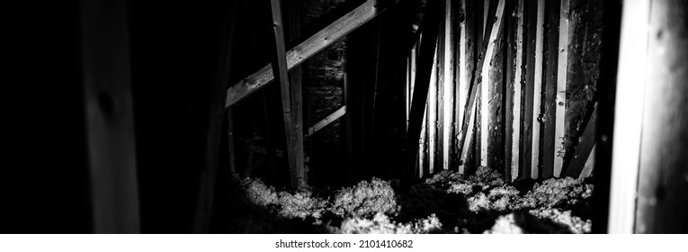 Dark Attic With Loose Blown Insulation Seen Throughout. 