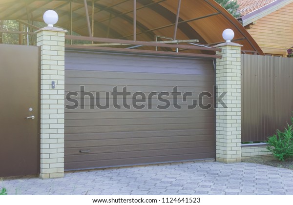 \
Dark automatic gates to\
the garage