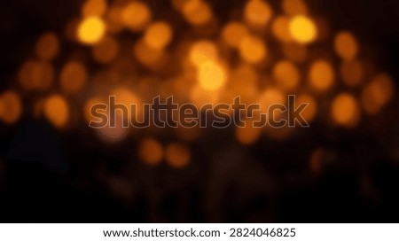 A dark background filled with soft, out-of-focus glowing bokeh lights in warm orange and yellow hues, creating a magical atmosphere.