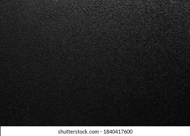 dark background of hammered powder paint coating on flat sheet steel surface