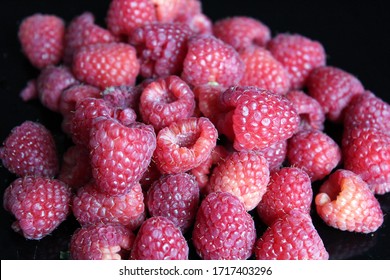 Dark Background With Handful Of Fresh-picked Raspberries For Low-calorie Snack In The Afternoon Slump.