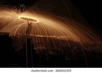 Dark background with light halo. Man with light. Long exposition. Pyramid. - Shutterstock ID 2065015193