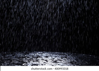 Dark background shot of rain falling