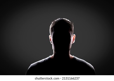 dark backlight shadow silhouette of male person, incognito unknown profile