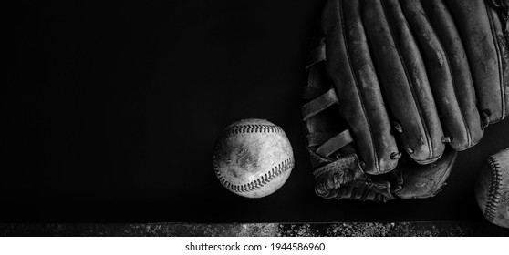 Dark baseball banner background with copy space beside old ball and glove.