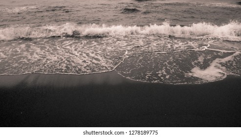 Dark beach and the waves