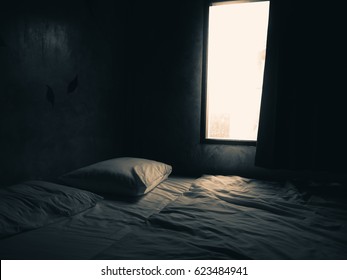Dark Bedroom With Light From The Window.