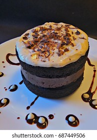 Dark Beer Stout Cake With Irish Cream Cheesecake Middle Layer, Topped With Cream Cheese Frosting And Fresh Shaved Chocolate Garnish