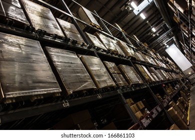 A Dark And Big Warehouse With A Lot Of Boxes On The Shelves