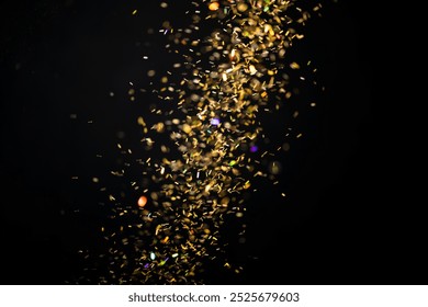 Dark black background with a cascade of golden, sparkling particles. The black background enhances the shimmering gold effect. Festive Christmas glitter on dark background. Gold glitter background. - Powered by Shutterstock